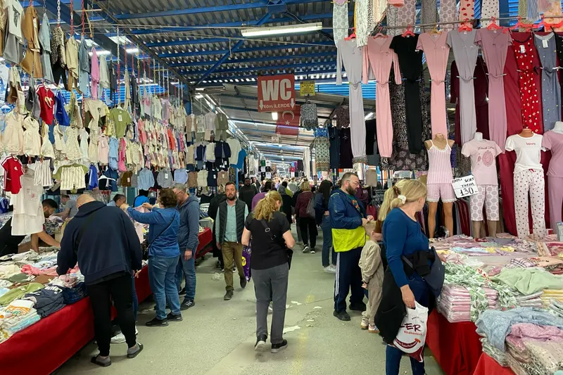 تصویری از راستۀ لباسفروشی در جمعهبازار استانبول با لباسهای راحتی و بچگانه